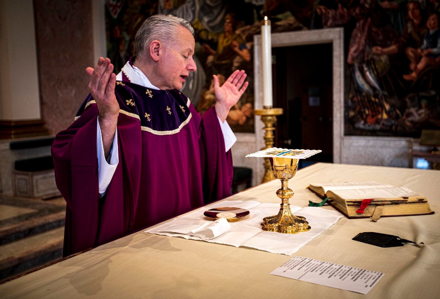 Father John C. Maria prays over the Eucharist at the altar of the Cathedral of St. Catharine of Siena in Allentown, Pa., March 9, 2020. According to Catholic teaching, the bread and wine, upon consecration, become the body and blood of Christ.