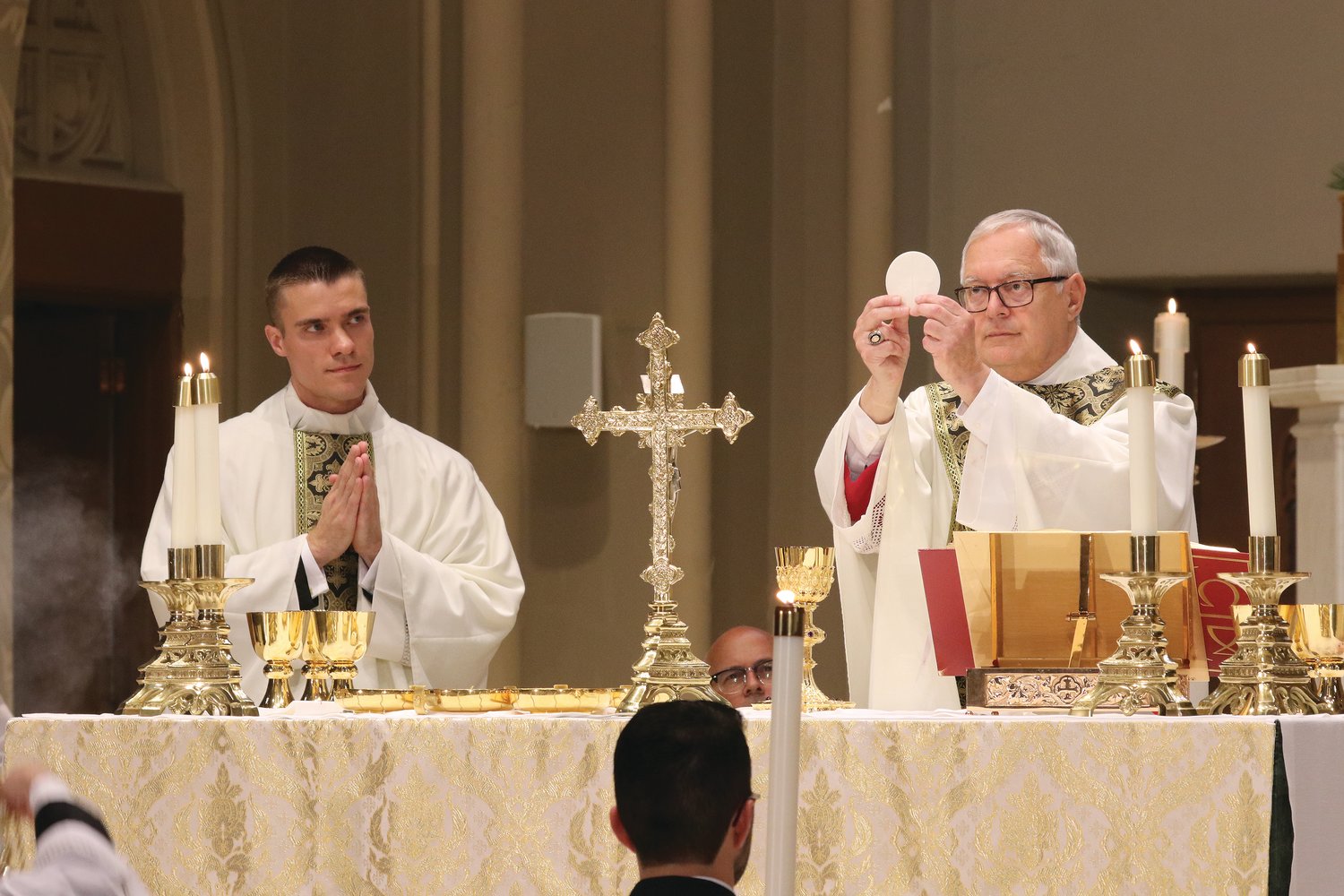 The newly ordained concelebrates Mass with Bishop Thomas J. Tobin.