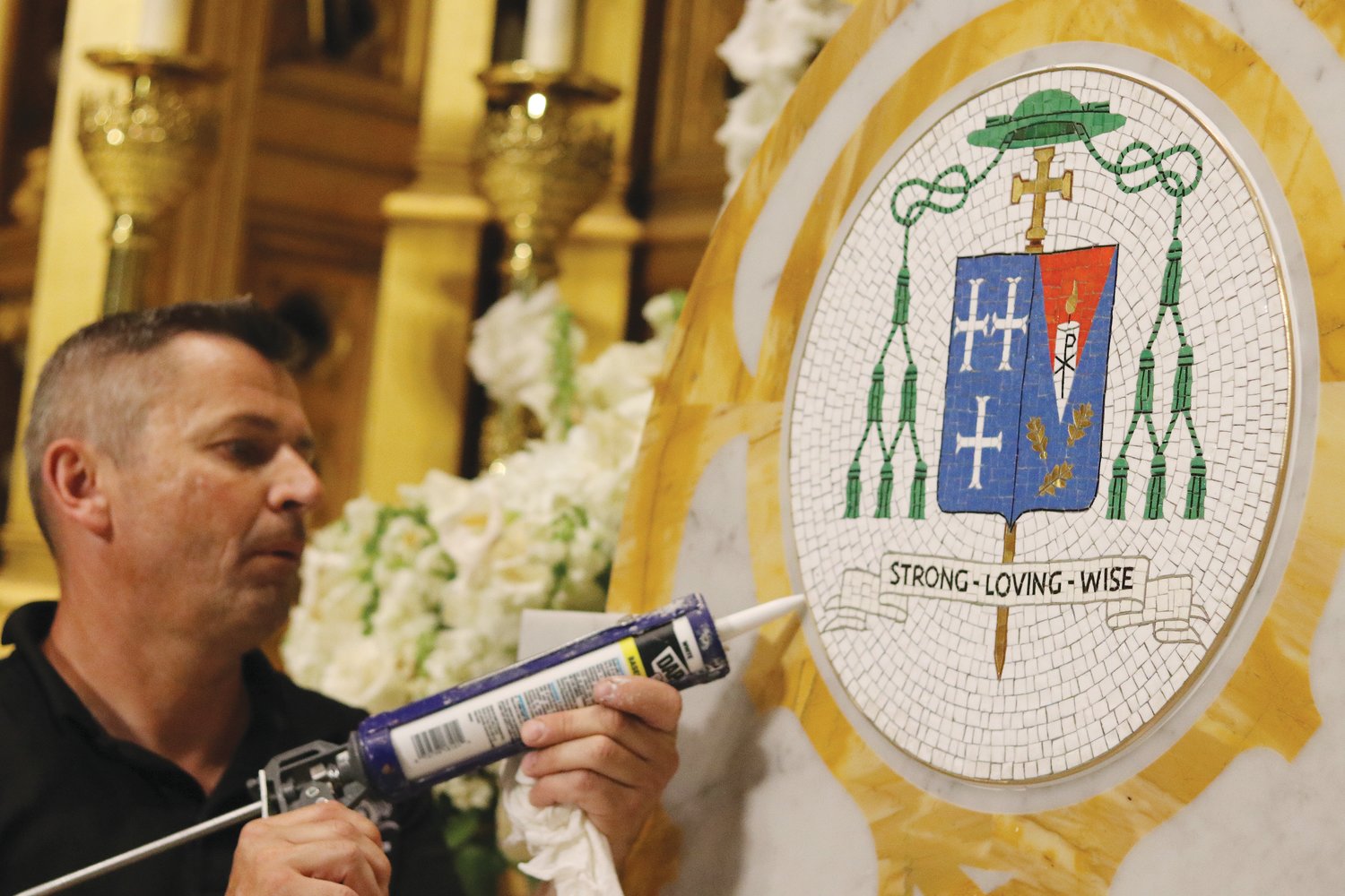 Gothic Owner, Michao Ruszkowski, seals Bishop Tobin’s crest into the new cathedra.