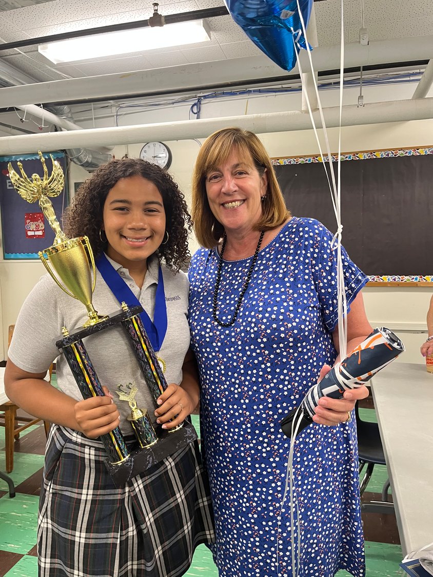 Sixth-grader Amani Migwi won first place for Rhode Island in SIFMA Foundation’s Spring 2022 National InvestWrite Competition. Migwi is pictured here with St. Margaret School principal Lee Ann Nunes.