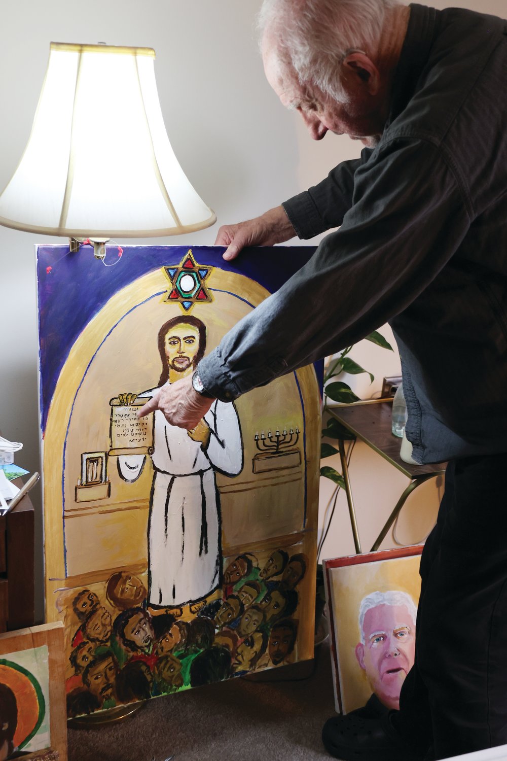 Father Robert Beirne displays a sample of his work.
