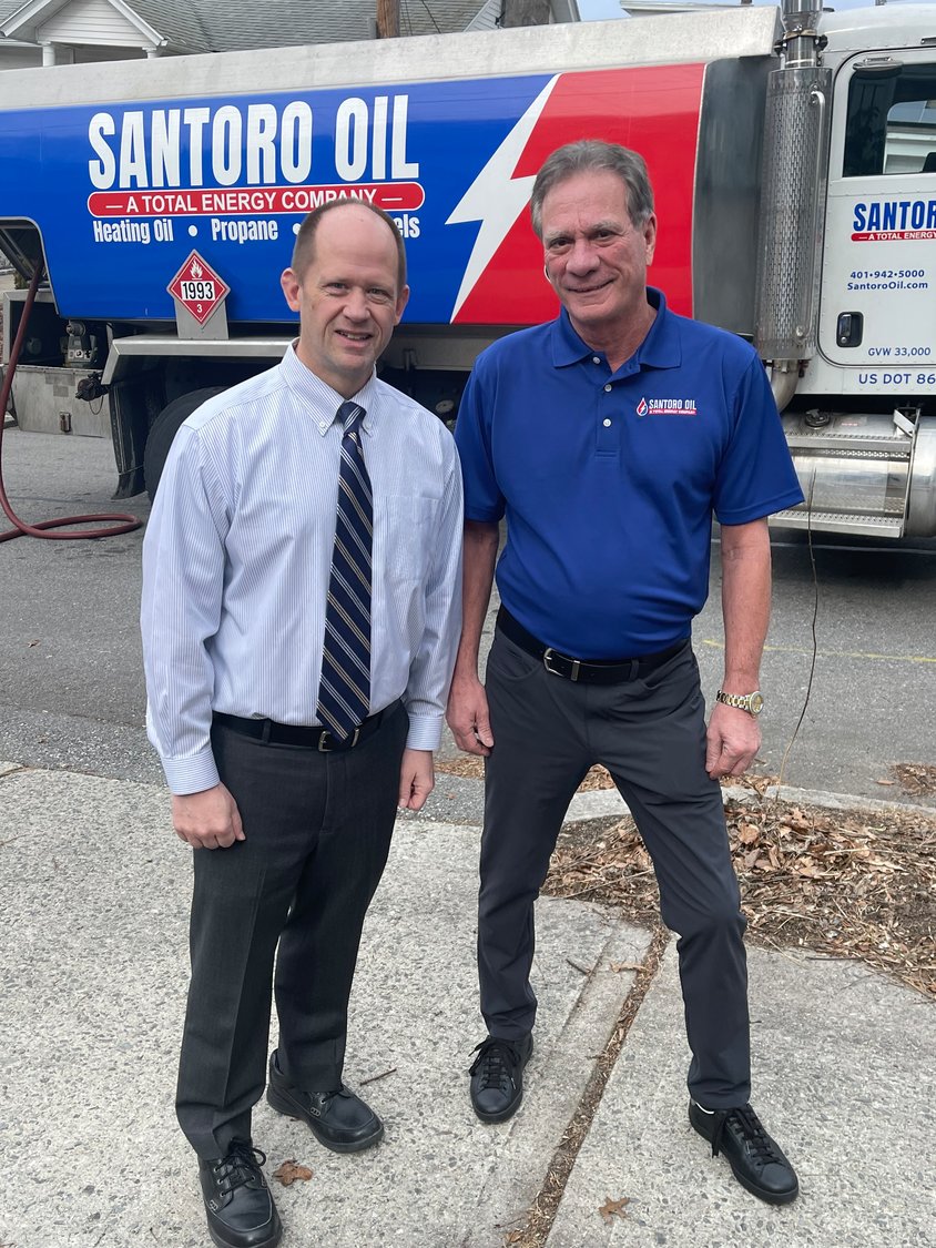 Diocesan Director of Catholic Charities and Social Ministries James Jahnz, left, greets Santoro Oil Company CEO John Santoro at a delivery site to thank him for his company’s generous $50,000 donation to Bishop Tobin’s Keep the Heat On Program.