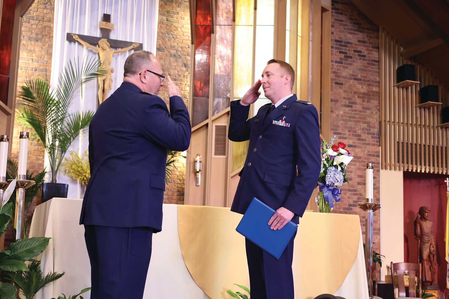 Col. Scott Hoyle salutes Lt. Col. David G. Thurber Jr. during his promotion.