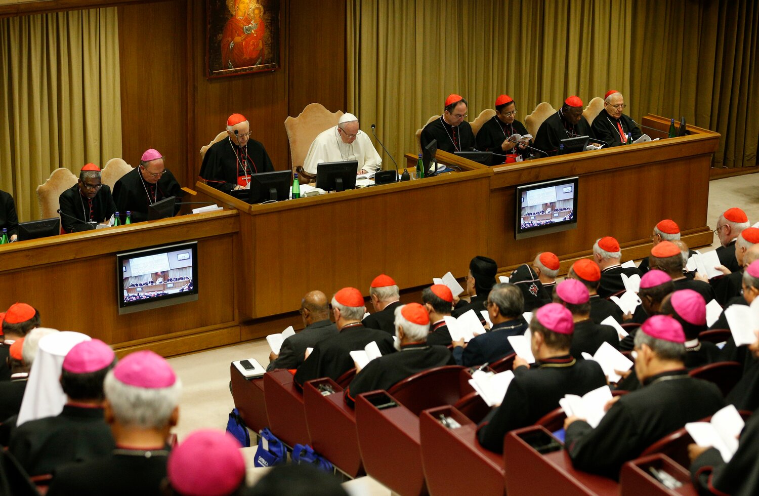 Pope Francis attends a session of the Synod of Bishops on young people in the Vatican synod hall in this file photo from 2018. The October assembly of the "synod on synodality" has been moved to the larger Vatican audience hall where members will sit at round tables, rather than in rows.
