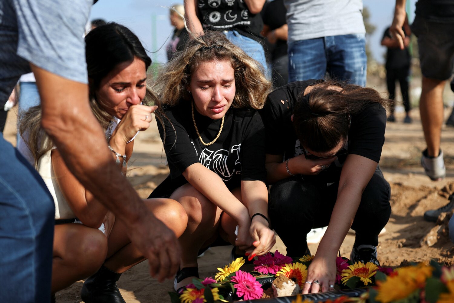 People mourn at the graveside of Eden Guez, during her funeral in Ashkelon, i Israel, October 10, 2023, who was killed as she attended a festival that was attacked by Hamas gunmen from Gaza. Israel increased airstrikes on the Gaza Strip and sealed it off from food, fuel and other supplies Monday in retaliation for a bloody incursion by Hamas militants, as the war’s death toll rose to nearly 1,600 on both sides. Hamas also escalated the conflict, pledging to kill captured Israelis if attacks targeted civilians without warnings.
