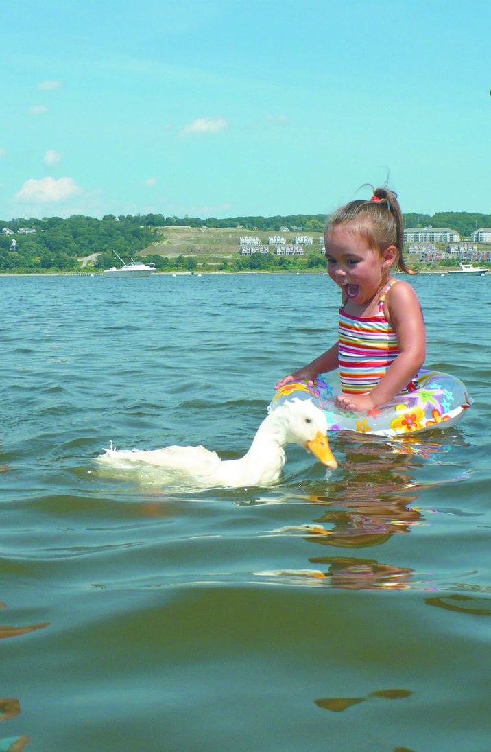ENJOYING SUMMER: Lemon swims in the Sakonnet River with Mackenzie Oliveira, a family friend.